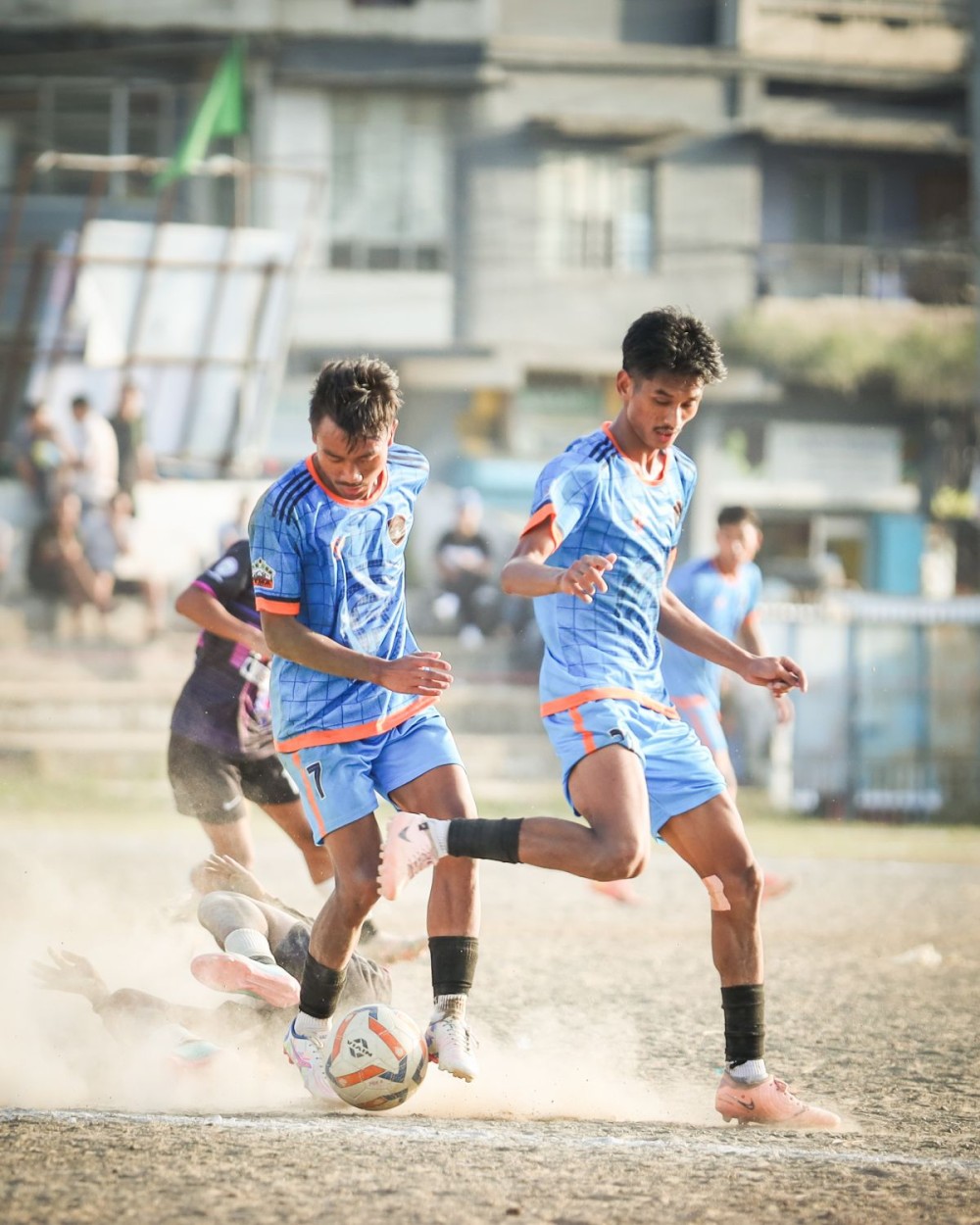 Chargers FC (in blue) and Telongjem FC (in black) in action during the second semifinal of the 27th MDFA Trophy 2025 at Imkongmeren Sports Complex, Mokokchung, on October 23.